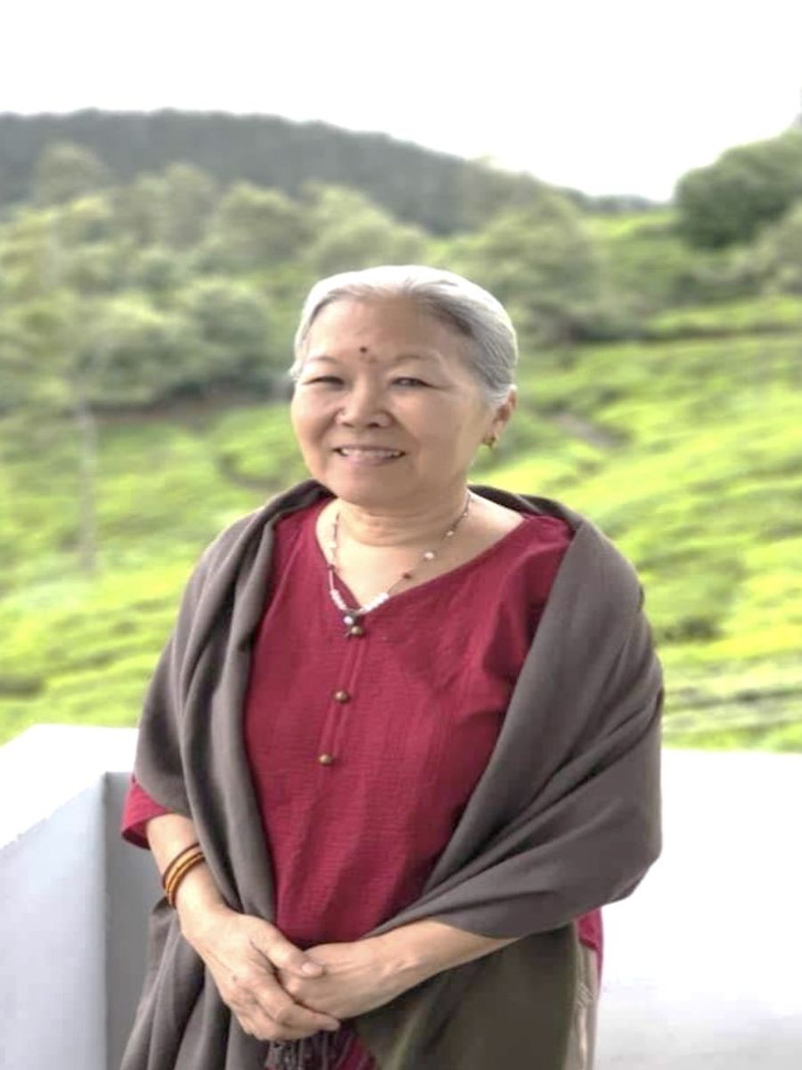 Dr. Laurel Kimura at the Mountain Top Clinic, with the tea hills behind her