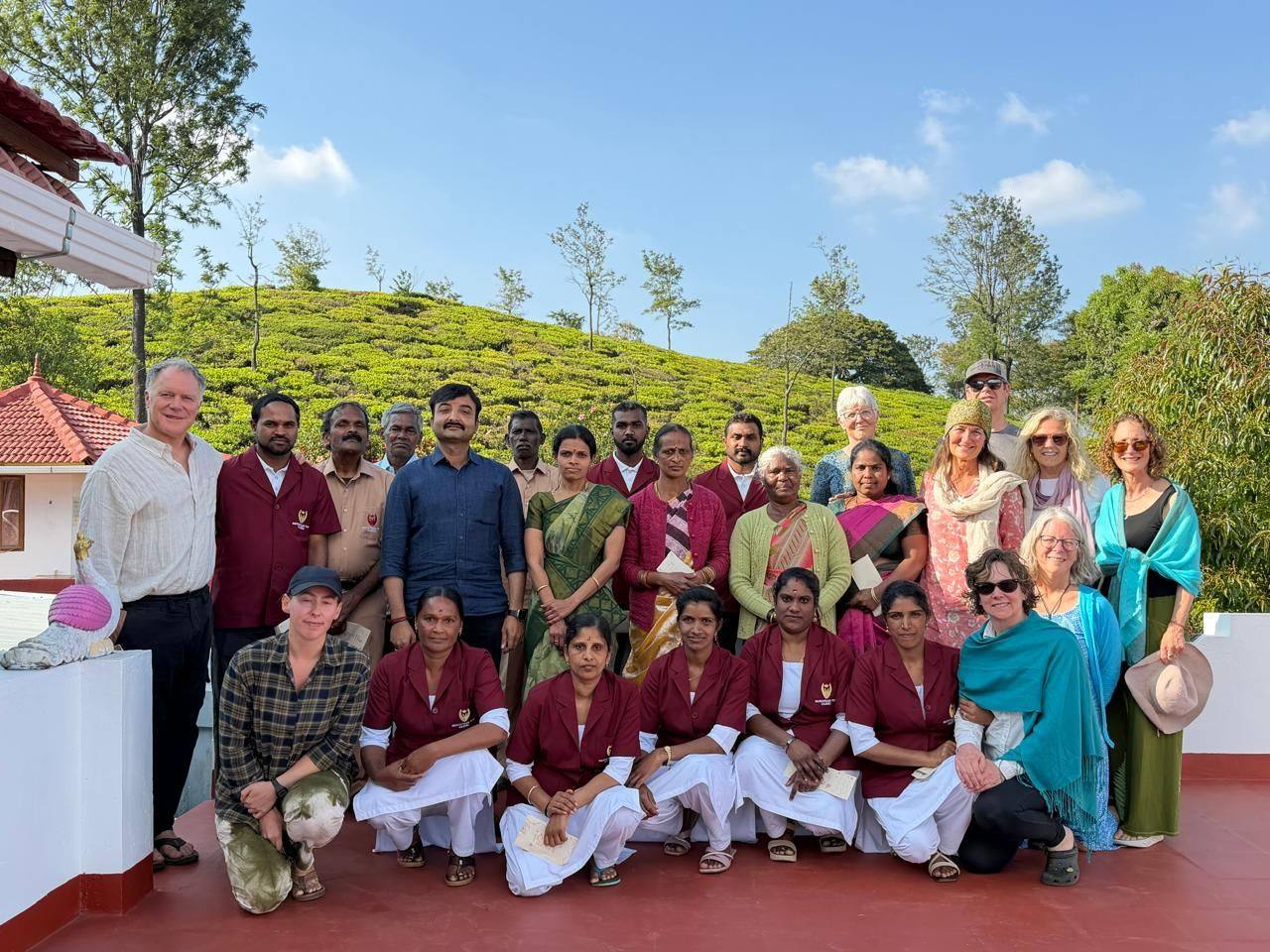 Mountain Top Clinic staff and guests gathered on the terrace above the tea hills